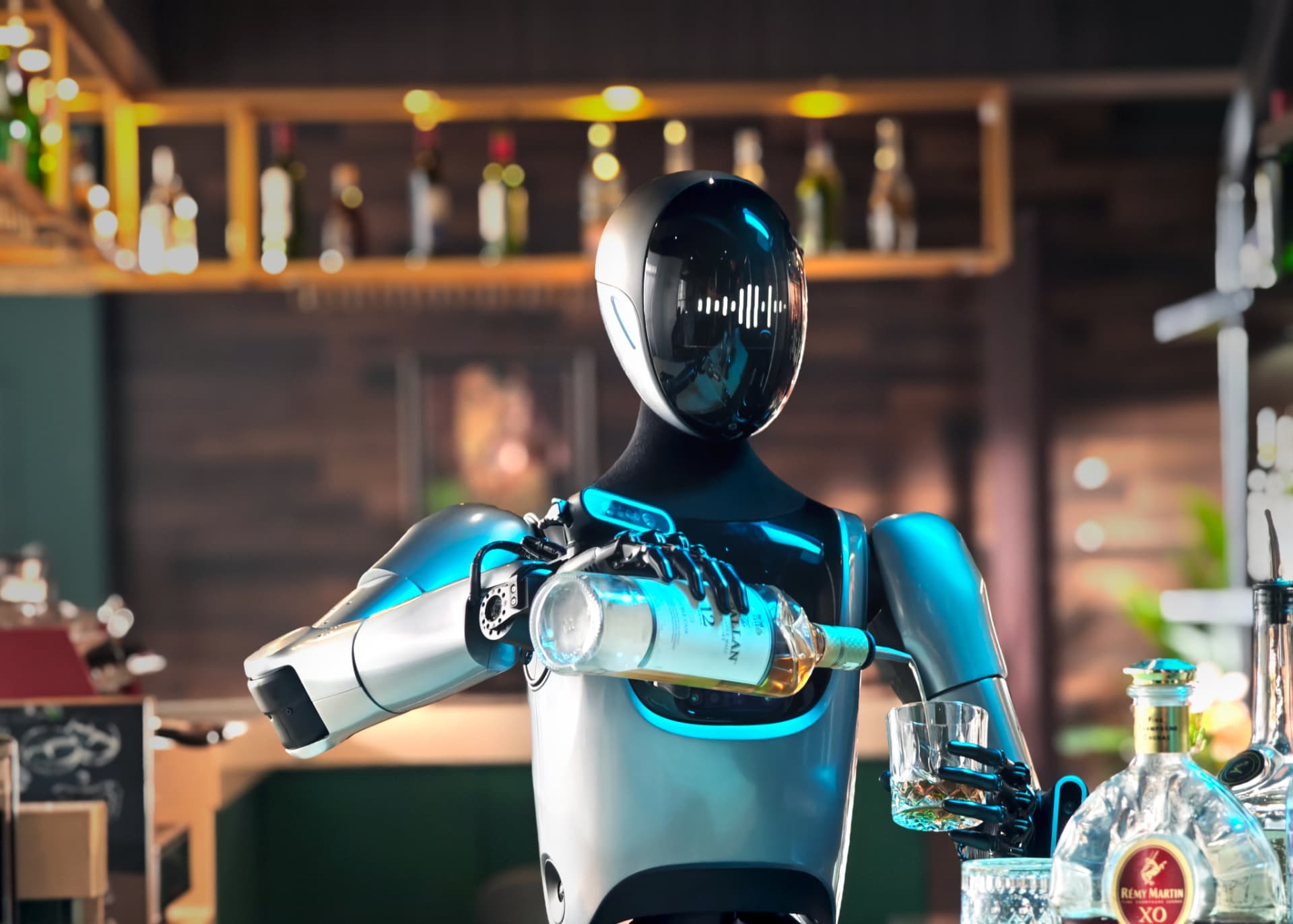 KEENON XMAN-R1 humanoid service robot pouring a drink behind a bar
