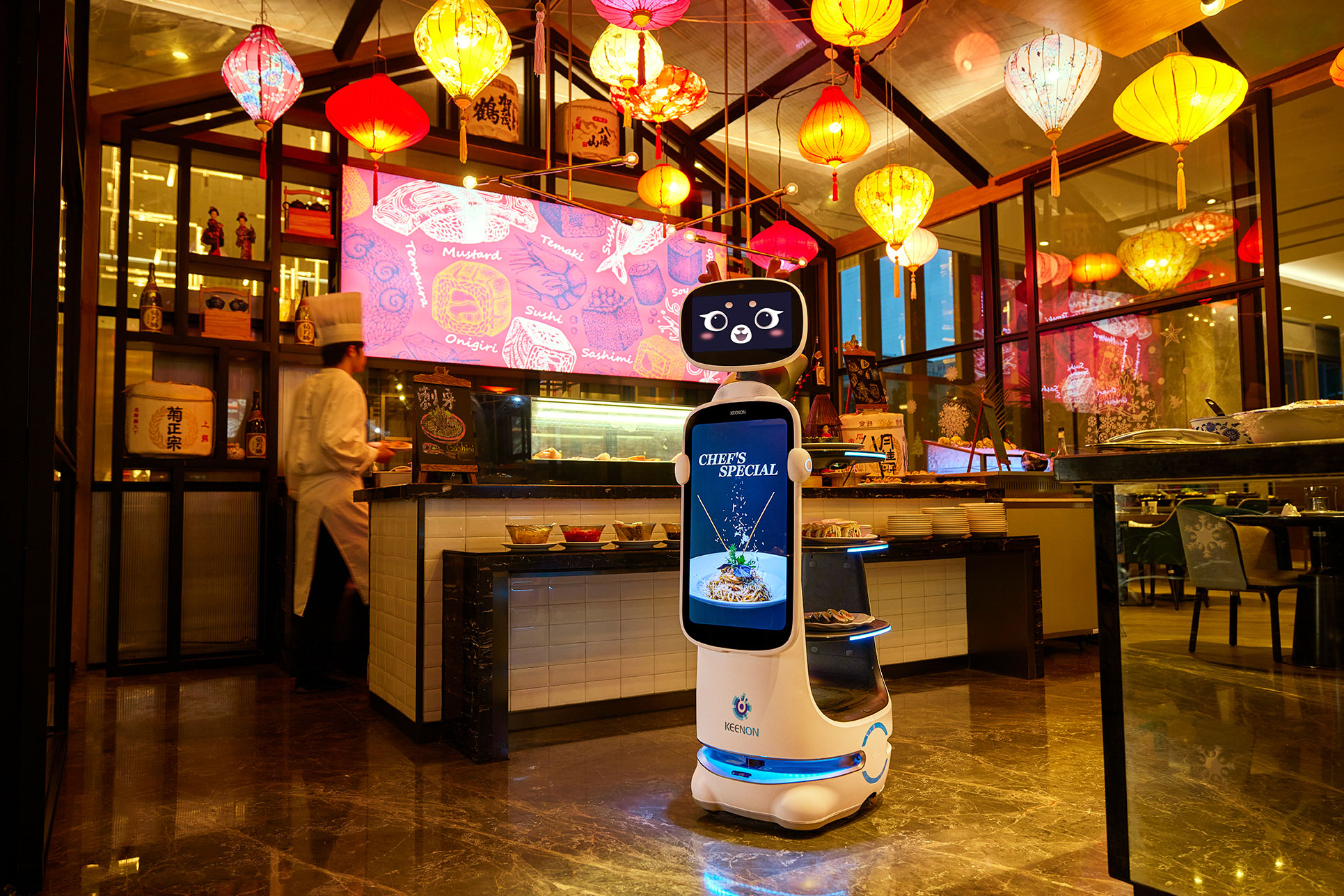 Keenon DINERBOT T10 with a Chef's Special promotion on its screen in a lantern-lit restaurant