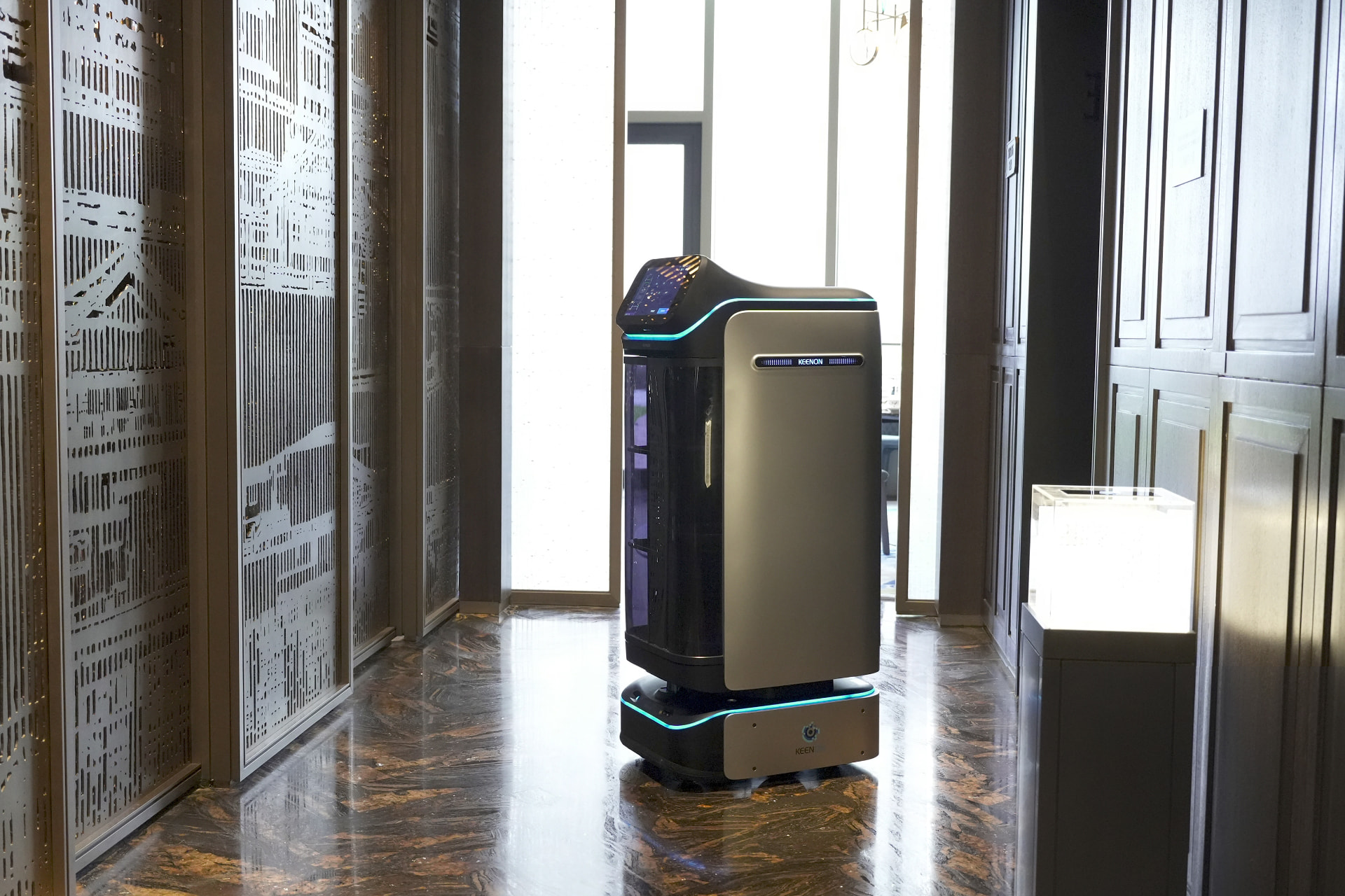 Keenon DINERBOT T3 with enclosed compartments delivering along a premium hotel corridor